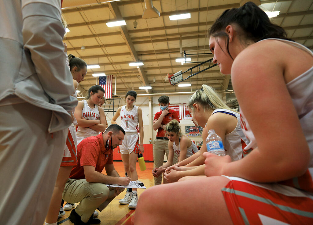 Harrisburg High School coach Ryan Richardson talks with his team